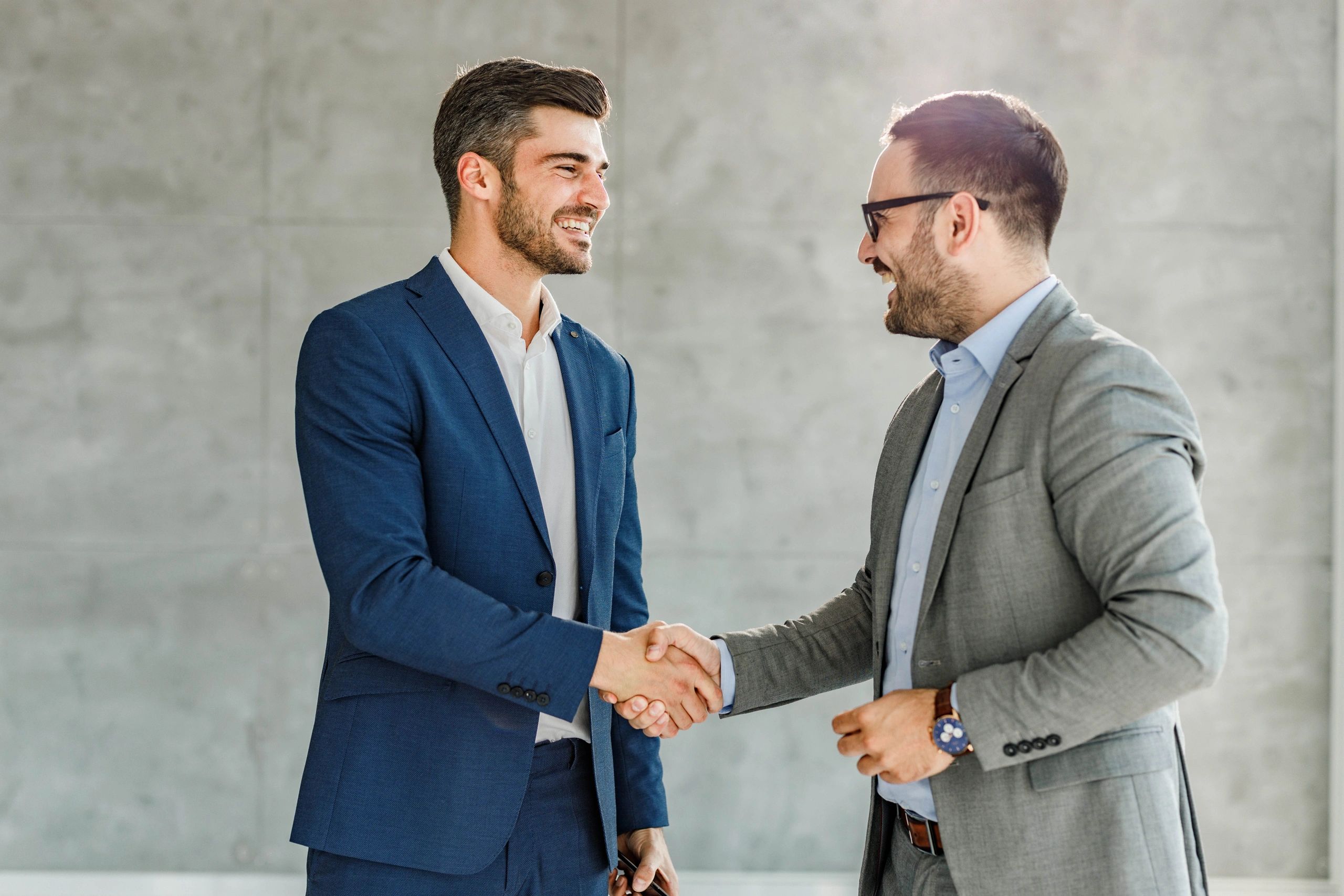 Two professionals shaking hands in an office